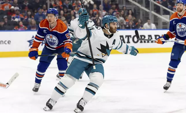 San Jose Sharks' Luke Kunin celebrates his goal against the Edmonton Oilers during the first period of an NHL hockey game in Edmonton, Alberta, Saturday, Dec. 21, 2024. (Timothy Matwey/The Canadian Press via AP)