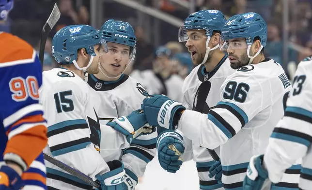 San Jose Sharks' Jan Rutta celebrates his goal against the Edmonton Oilers with his teammates during the first period of an NHL hockey game in Edmonton, Alberta, Saturday, Dec. 21, 2024. (Timothy Matwey/The Canadian Press via AP)