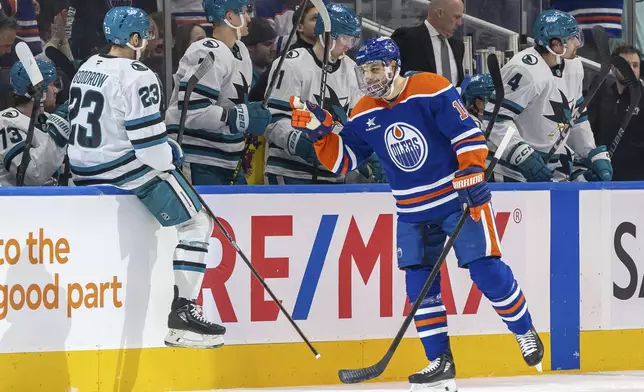 Edmonton Oilers' Zach Hyman (18) skates past the San Jose Sharks bench as he celebrates his goal during the first period of an NHL hockey game in Edmonton, Alberta, Saturday, Dec. 21, 2024. (Timothy Matwey/The Canadian Press via AP)