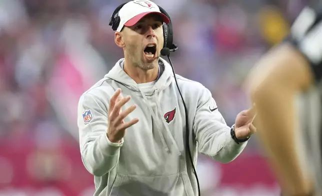 Arizona Cardinals head coach Jonathan Gannon looks for a call during the second half of an NFL football game against the Seattle Seahawks, Sunday, Dec. 8, 2024, in Glendale, Ariz. (AP Photo/Ross D. Franklin)