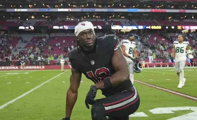 Arizona Cardinals wide receiver Marvin Harrison Jr. takes a knee after an NFL football game against the Seattle Seahawks, Sunday, Dec. 8, 2024, in Glendale, Ariz. (AP Photo/Rick Scuteri)