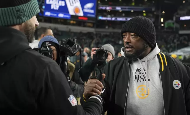 Philadelphia Eagles head coach Nick Sirianni, left, greets Pittsburgh Steelers head coach Mike Tomlin after an NFL football game Sunday, Dec. 15, 2024, in Philadelphia. (AP Photo/Matt Slocum)