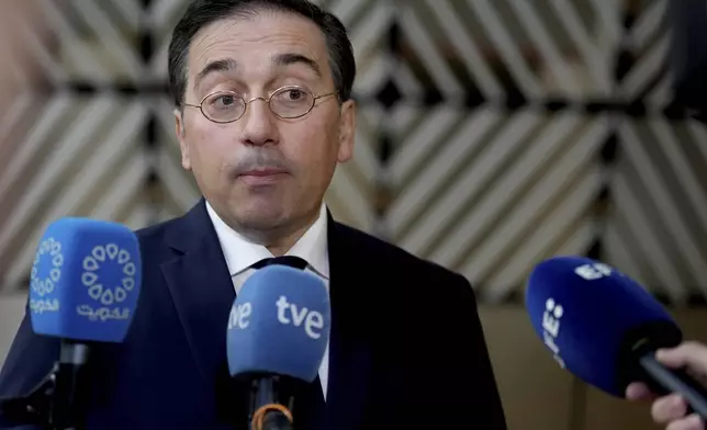 Spain's Foreign Minister Jose Manuel Albares Bueno speaks with the media as he arrives for a meeting of EU foreign ministers at the European Council building in Brussels, Monday, Dec. 16, 2024. (AP Photo/Virginia Mayo)