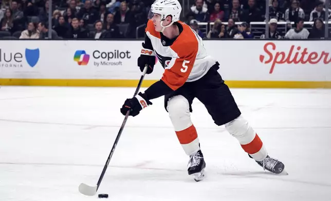 Philadelphia Flyers defenseman Egor Zamula controls the puck during the second period of an NHL hockey game against the Los Angeles Kings, Sunday, Dec. 29, 2024, in Los Angeles. (AP Photo/William Liang)