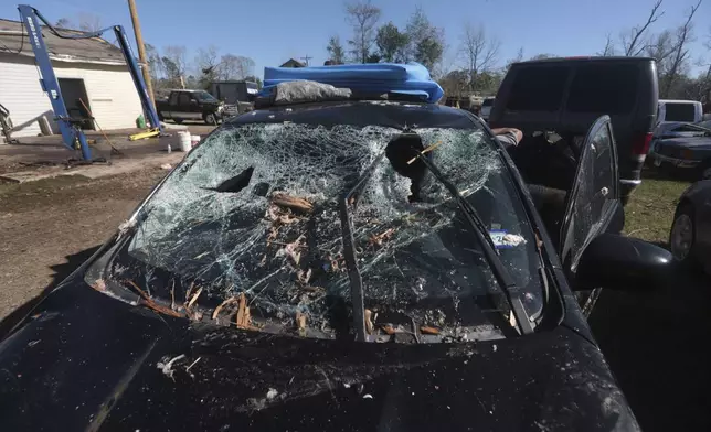 CORRECTS LOCATION The windshield of a car near New Caney, Texas, is left smashed on Monday, Dec. 30, 2024, following a strong weekend storm system that spawned hail, rain, high winds and tornadoes across the southern U.S. (AP Photo/Lekan Oyekanmi)