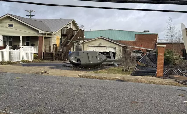 A military helicopter that was toppled from its perch in a military veterans park during a violent storm is seen on Sunday, Dec. 29, 2024, in Athens, Alabama. (AP Photo/Lance George)