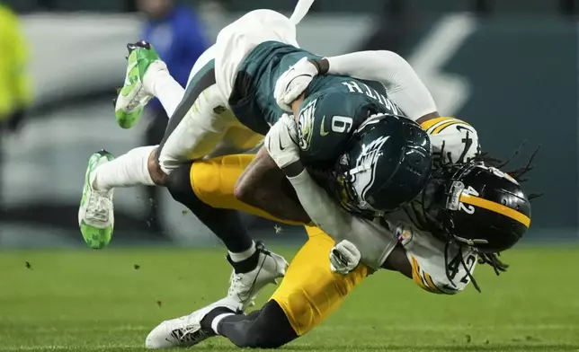 Philadelphia Eagles wide receiver DeVonta Smith (6) is brought down by Pittsburgh Steelers cornerback James Pierre (42) during the second half of an NFL football game Sunday, Dec. 15, 2024, in Philadelphia. (AP Photo/Matt Slocum)