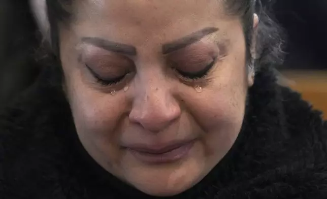 A Syrian Christians woman cries, as she attends the first Sunday Mass since Syrian President Bashar Assad's ouster, at Mariamiya Orthodox Church in old Damascus, Syria, Sunday, Dec. 15, 2024. (AP Photo/Hussein Malla)