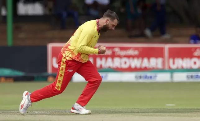 Zimbabwe's Ryan Burl celebrates a wicket during the third T20 cricket match between Zimbabwe and Pakistan at Queens Sports Club in Bulawayo, Zimbabwe, Thursday, Dec. 5, 2024. (AP Photo/Wonder Mashura)