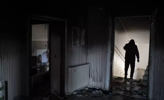 A man walks through ousted Syrian President Bashar Assad's damaged family property in Qardaha, Syria, on Tuesday, Dec. 17, 2024. (AP Photo/Leo Correa)