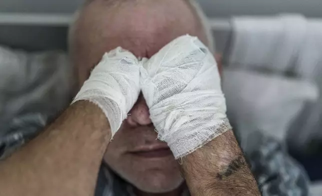 Stanislav, an injured Russian prisoner of war, lies in bed at the detention center in Ukraine's Lviv region, Thursday, April 25, 2024. (AP Photo/Evgeniy Maloletka)