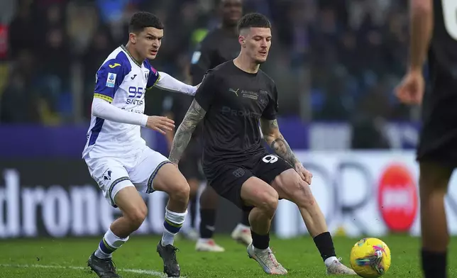 Parma's Dennis Man fights for the ball with Verona's Reda Belahyane during the Serie A soccer match between Parma and Hellas Verona at Tardini Stadium in Parma, North Italy, Sunday, Dec. 15 , 2024. (Spada/LaPresse via AP)