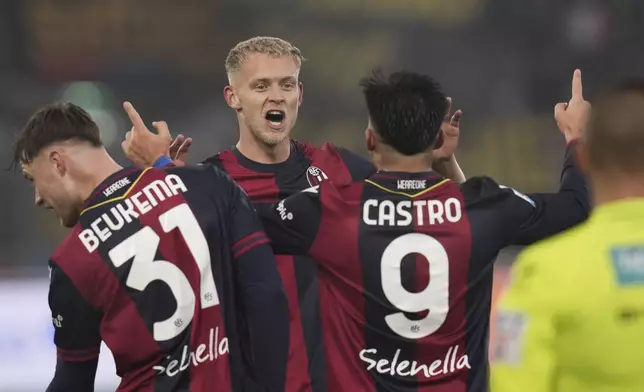 Bologna's Jens Odgaard celebrates after scoring his side's first goal during the Serie A soccer match between Bologna and Fiorentina, at Renato Dall'Ara Stadium in Bologna, Italy, Sunday Dec. 15, 2024. (Massimo Paolone/LaPresse via AP)