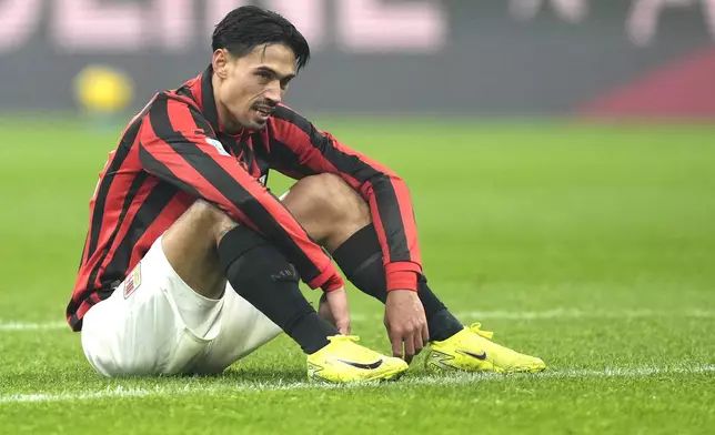 AC Milan's Tijjani Reijnders reacts during the Serie A soccer match between AC Milan and Genoa at the San Siro stadium, in Milan, Italy, Sunday, Dec. 15, 2024. (AP Photo/Antonio Calanni)