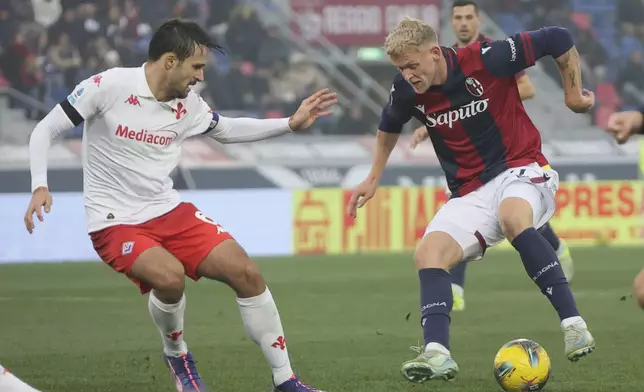 Bologna's Jens Odgaard fights for the ball with Fiorentina's Luca Ranieri during the Serie A soccer match between Bologna and Fiorentina, at Renato Dall'Ara Stadium in Bologna, Italy, Sunday Dec. 15, 2024. (Michele Nucci /LaPresse via AP)