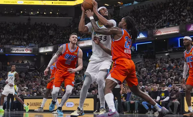 Indiana Pacers center Myles Turner (33) shoots over Oklahoma City Thunder guard Cason Wallace (22) during the second half of an NBA basketball game in Indianapolis, Thursday, Dec. 26, 2024. (AP Photo/Michael Conroy)