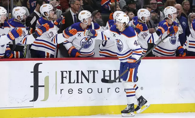 Edmonton Oilers right wing Kasperi Kapanen is congratulated for his goal against the Minnesota Wild during the first period of an NHL hockey game Thursday, Dec. 12, 2024, in St. Paul, Minn. (AP Photo/Matt Krohn)