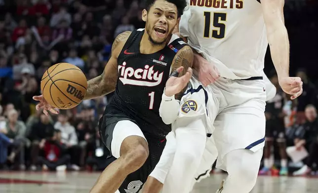 Portland Trail Blazers guard Anfernee Simons (1) dribbles around Denver Nuggets center Nikola Jokic (15) during the second half of an NBA basketball game in Portland, Ore., Thursday, Dec. 19, 2024. (AP Photo/Craig Mitchelldyer)