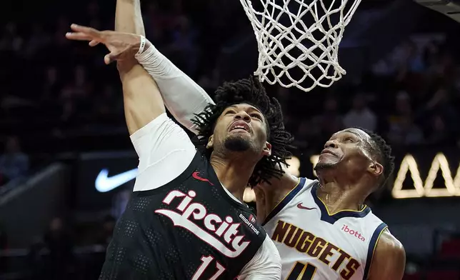 Portland Trail Blazers guard Shaedon Sharpe (17) is fouled by Denver Nuggets guard Russell Westbrook (4) during the second half of an NBA basketball game in Portland, Ore., Thursday, Dec. 19, 2024. (AP Photo/Craig Mitchelldyer)