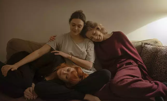 This image released by Netflix shows Natasha Lyonne, from left, Elizabeth Olsen, and Carrie Coon in a scene from "His Three Daughters." (Netflix via AP)