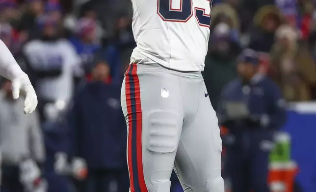 New England Patriots tight end Hunter Henry (85) motions after a first down against the Buffalo Bills during the first quarter of an NFL football game, Sunday, Dec. 22, 2024, in Orchard Park, N.Y. (AP Photo/Jeffrey T. Barnes)