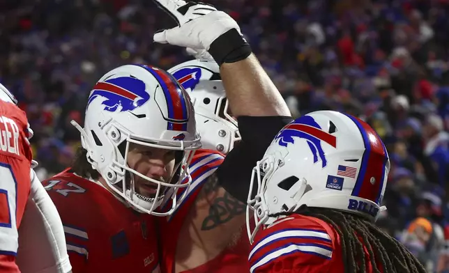 Buffalo Bills quarterback Josh Allen (17) congratulates Buffalo Bills running back James Cook (4) after a touchdown against the New England Patriots during the second quarter of an NFL football game, Sunday, Dec. 22, 2024, in Orchard Park, N.Y.. (AP Photo/Jeffrey T. Barnes)