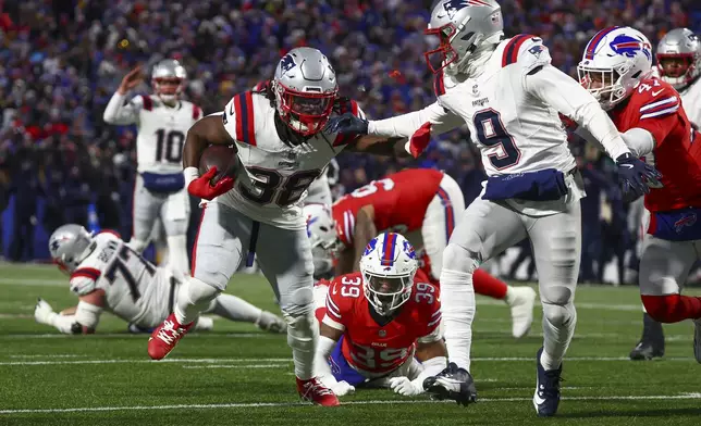 New England Patriots running back Rhamondre Stevenson (38) carries the ball for a touchdown against the Buffalo Bills during the second quarter of an NFL football game, Sunday, Dec. 22, 2024, in Orchard Park, N.Y.. (AP Photo/Jeffrey T. Barnes)