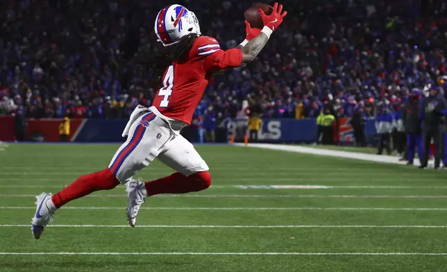 Buffalo Bills running back James Cook (4) makes a touchdown catch against the New England Patriots during the third quarter of an NFL football game, Sunday, Dec. 22, 2024, in Orchard Park, N.Y.. (AP Photo/Jeffrey T. Barnes)