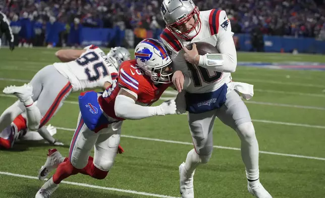 Buffalo Bills cornerback Cam Lewis (39) forces New England Patriots quarterback Drake Maye (10) out of bounds during the first quarter of an NFL football game, Sunday, Dec. 22, 2024, in Orchard Park, N.Y.. (AP Photo/Gene J. Puskar)