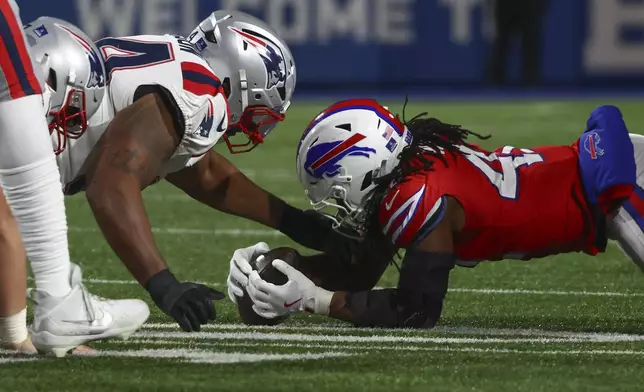 Buffalo Bills linebacker Dorian Williams (42) recovers a fumble against the New England Patriots during the third quarter of an NFL football game, Sunday, Dec. 22, 2024, in Orchard Park, N.Y.. (AP Photo/Jeffrey T. Barnes)