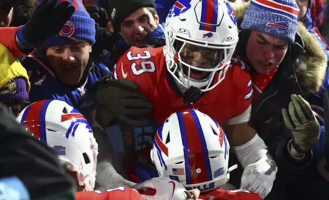 Buffalo Bills cornerback Cam Lewis (39) celebrates with fans and teammates after intercepting a pass in the end zone against the New England Patriots during the third quarter of an NFL football game, Sunday, Dec. 22, 2024, in Orchard Park, N.Y.. (AP Photo/Jeffrey T. Barnes)