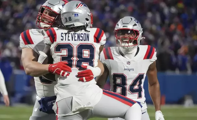 New England Patriots running back Rhamondre Stevenson (38) celebrates with teammates after scoring a touchdown against the Buffalo Bills during the second quarter of an NFL football game, Sunday, Dec. 22, 2024, in Orchard Park, N.Y.. (AP Photo/Gene J. Puskar)