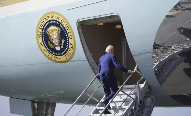 President Joe Biden boards Air Force One at Amilcar Cabral international airport on Sal island, Cape Verde Monday, Dec. 2, 2024, en route to Angola as he makes his long-promised visit to Africa. (AP Photo/Ben Curtis)