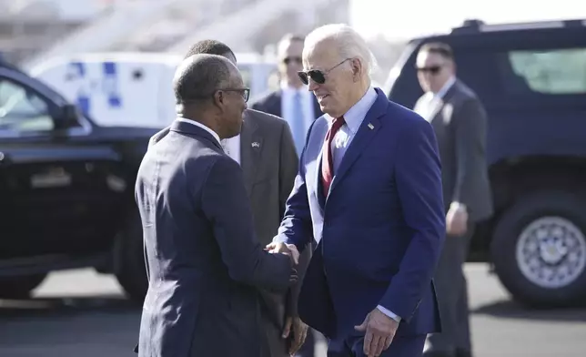 President Joe Biden is greeted by Cape Verde's Prime Minister Ulisses Correia e Silva at Amilcar Cabral international airport on Sal island, Cape Verde Monday, Dec. 2, 2024, en route to Angola as he makes his long-promised visit to Africa. (AP Photo/Ben Curtis)