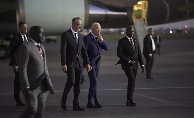 President Joe Biden is greeted by Angolan Foreign Minister Tete Antonio as he arrives at Quatro de Fevereiro international airport in the capital Luanda, Angola on Monday, Dec. 2, 2024, on his long-promised visit to Africa. (AP Photo/Ben Curtis)