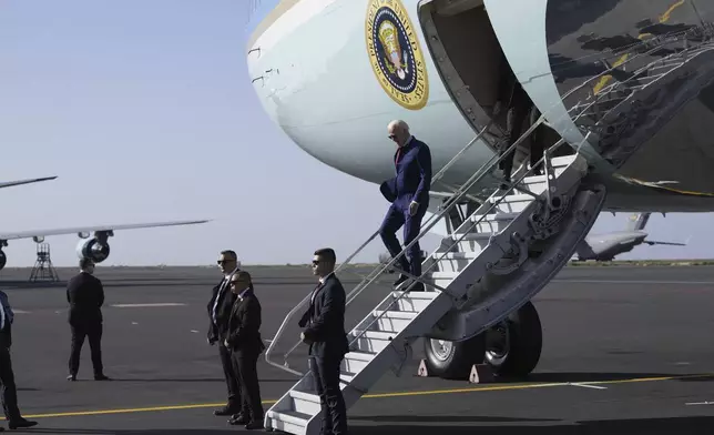 President Joe Biden walks from Air Force One at Amilcar Cabral international airport on Sal island, Cape Verde Monday, Dec. 2, 2024, en route to Angola as he makes his long-promised visit to Africa. (AP Photo/Ben Curtis)