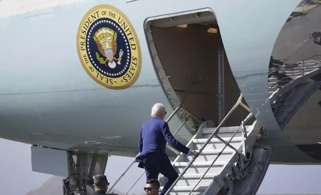 President Joe Biden boards Air Force One at Amilcar Cabral international airport on Sal island, Cape Verde Monday, Dec. 2, 2024, en route to Angola as he makes his long-promised visit to Africa. (AP Photo/Ben Curtis)