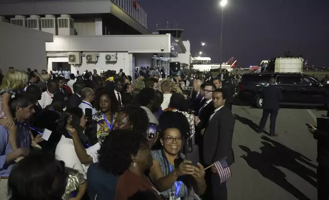 President Joe Biden greets well wishers as he arrives at Quatro de Fevereiro international airport in the capital Luanda, Angola on Monday, Dec. 2, 2024, on his long-promised visit to Africa. (AP Photo/Ben Curtis)