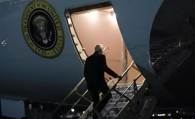 President Joe Biden boards Air Force One at Joint Base Andrews, Md., Sunday, Dec. 1, 2024, en route to Angola as he makes his long-promised visit to Africa. (AP Photo/Ben Curtis)