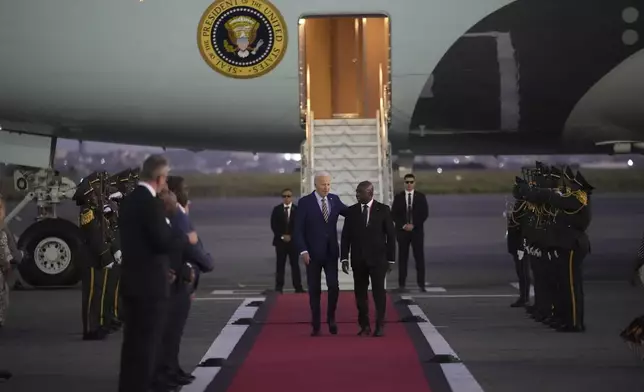 President Joe Biden is greeted by Angolan Foreign Minister Tete Antonio as he arrives at Quatro de Fevereiro international airport in the capital Luanda, Angola on Monday, Dec. 2, 2024, on his long-promised visit to Africa. (AP Photo/Ben Curtis)