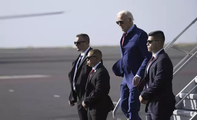 President Joe Biden walks from Air Force One at Amilcar Cabral international airport on Sal island, Cape Verde Monday, Dec. 2, 2024, en route to Angola as he makes his long-promised visit to Africa. (AP Photo/Ben Curtis)