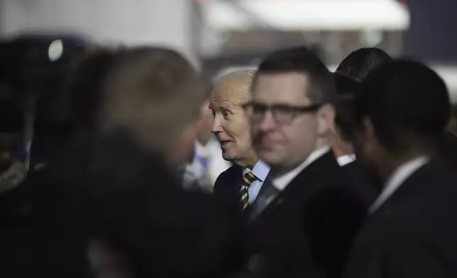 President Joe Biden greets well wishers after arriving at Quatro de Fevereiro international airport in the capital Luanda, Angola on Monday, Dec. 2, 2024, on his long-promised visit to Africa. (AP Photo/Ben Curtis)