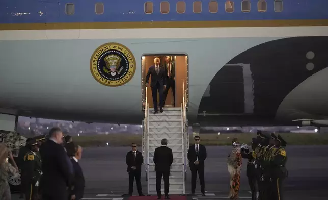 President Joe Biden walks from Air Force One as he arrives at Quatro de Fevereiro international airport in the capital Luanda, Angola on Monday, Dec. 2, 2024, on his long-promised visit to Africa. (AP Photo/Ben Curtis)