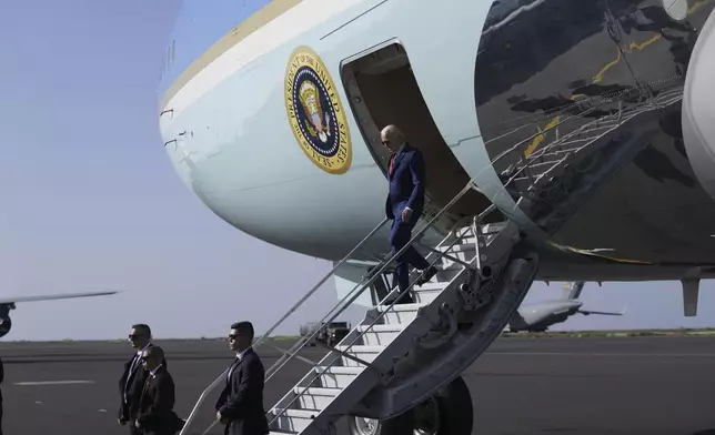 President Joe Biden walks from Air Force One at Amilcar Cabral international airport on Sal island, Cape Verde Monday, Dec. 2, 2024, en route to Angola as he makes his long-promised visit to Africa. (AP Photo/Ben Curtis)