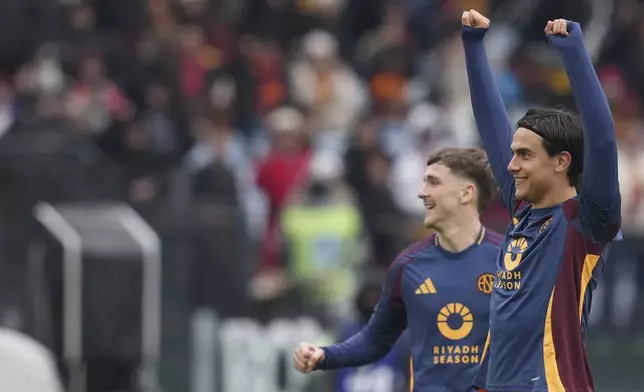 Roma's Paulo Dybala, right, celebrates after scoring his side's third goal during the Italian Serie A soccer match between Roma and Parma at Rome's Olympic stadium, Sunday Dec. 22, 2024. (Alfredo Falcone/LaPresse via AP)