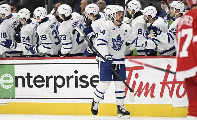 Toronto Maple Leafs center Auston Matthews (34) celebrates after scoring a goal against the Detroit Red Wings during the second period of an NHL hockey game, Saturday, Dec. 14, 2024 in Detroit. (AP Photo/Lon Horwedel)