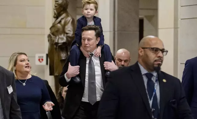 Elon Musk, President-elect Donald Trump's pick for the planned Department of Government Efficiency, carries his son X Æ A-Xii on his shoulders, following a meeting with members of Congress at the Capitol, Thursday, Dec. 5, 2024, in Washington. (AP Photo/Rod Lamkey, Jr.)