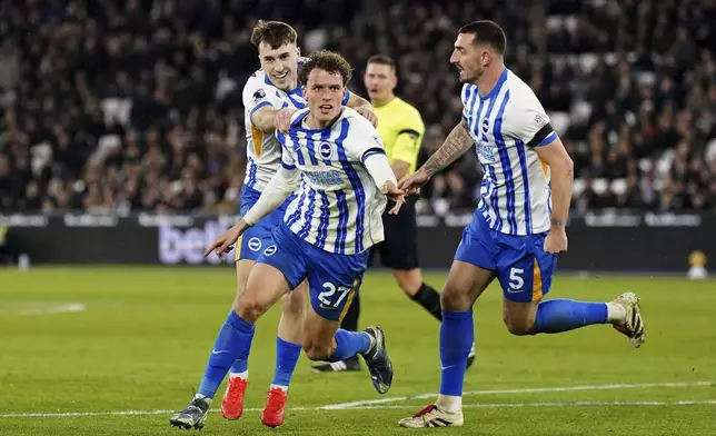 Brighton and Hove Albion's Mats Wieffer, center, celebrates scoring with teammates during the English Premier League soccer match between West Ham United and Brighton &amp; Hove Albion at the London Stadium, London, Saturday Dec 21, 2024. (Ben Whitley/PA via AP)