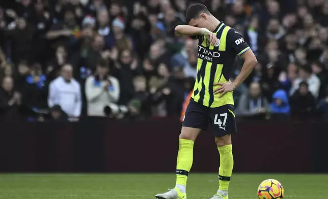 Manchester City's Phil Foden reacts after Aston Villa's Morgan Rogers scoring his side's second goal during the English Premier League soccer match between Aston Villa and Manchester City, at Villa Park in Birmingham, England, Saturday, Dec. 21, 2024. (AP Photo/Rui Vieira)