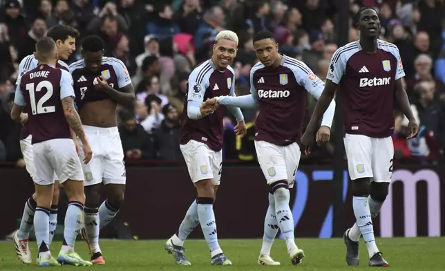 Aston Villa's Morgan Rogers, center, celebrates with teammates after scoring his side's second goal during the English Premier League soccer match between Aston Villa and Manchester City, at Villa Park in Birmingham, England, Saturday, Dec. 21, 2024. (AP Photo/Rui Vieira)